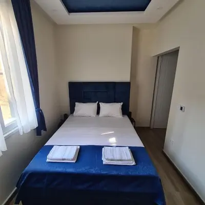 a bedroom with a blue bed with two towels on it at Up Apartments in Belgrade