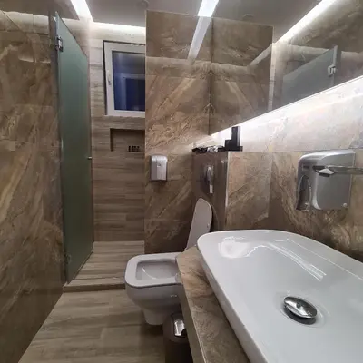 a bathroom with a white sink and a toilet at Up Apartments in Belgrade