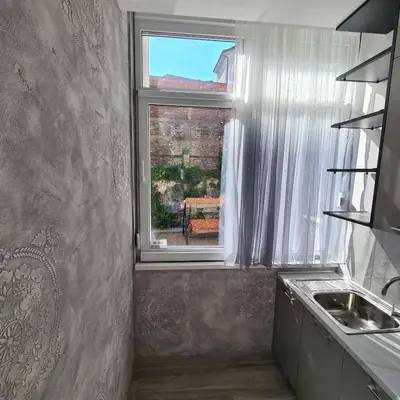 a kitchen with a sink and a window at Up Apartments in Belgrade