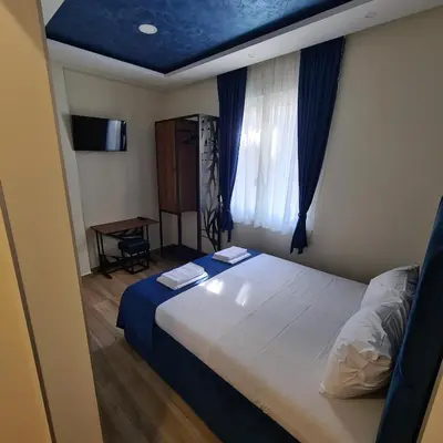 a bedroom with a bed with a blue ceiling at Up Apartments in Belgrade