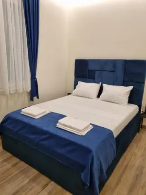a bedroom with a blue and white bed with towels on it at Up Apartments in Belgrade