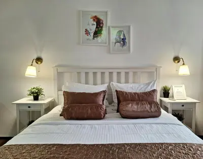 a bedroom with a large bed with two night stands at GENIUS STUDIO in Belgrade