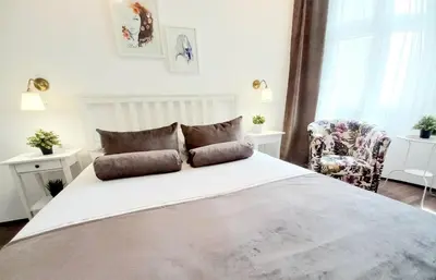 a bedroom with a large white bed with two pillows at GENIUS STUDIO in Belgrade