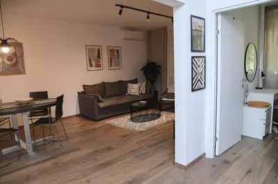 a living room with a couch and a table at Apartment GREEN in Belgrade