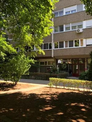an apartment building with trees in front of it at Apartment GREEN in Belgrade