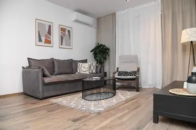 a living room with a couch and a chair at Apartment GREEN in Belgrade
