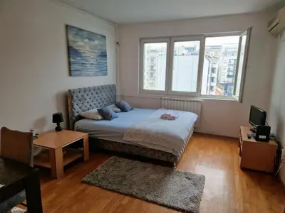 a small bedroom with a bed and a window at Anchy Apartment in Belgrade