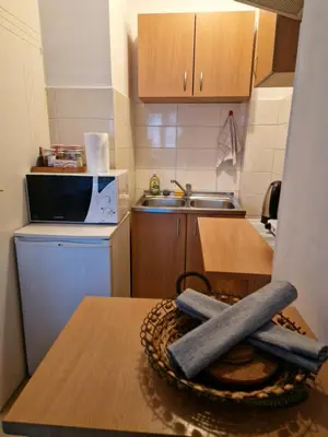 a small kitchen with a table with a cross on it at Anchy Apartment in Belgrade