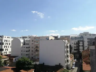 a large white building in a city with buildings at Anchy Apartment in Belgrade