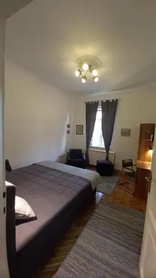 a bedroom with a bed and a living room at Fortress 1: Quiet, Lux 50m2 , apartment in the pedestrian zone in Belgrade