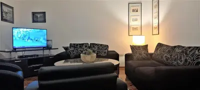 a living room with two couches and a tv at Fortress 1: Quiet, Lux 50m2 , apartment in the pedestrian zone in Belgrade