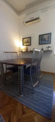 a dining room with a table and two chairs at Fortress 1: Quiet, Lux 50m2 , apartment in the pedestrian zone in Belgrade