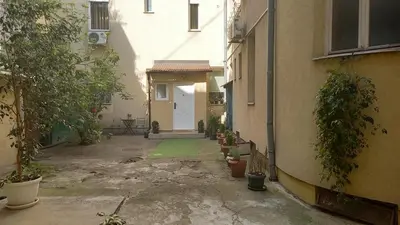an alley with a white door and a building at Fortress 1: Quiet, Lux 50m2 , apartment in the pedestrian zone in Belgrade