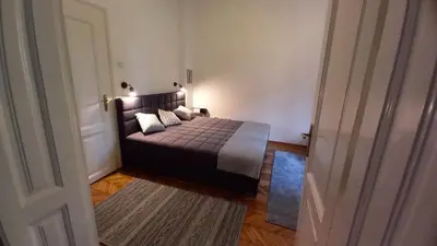 a bedroom with a bed in a room with a doorway at Fortress 1: Quiet, Lux 50m2 , apartment in the pedestrian zone in Belgrade