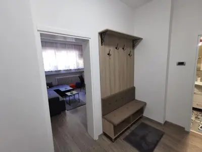 a hallway leading to a room with a desk at Apartman PAVLOVIC 1 in Dedinje