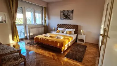 a bedroom with a bed and a large window at Windows City Apartment in Belgrade