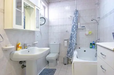 a bathroom with a sink and a toilet and a tub at Windows City Apartment in Belgrade