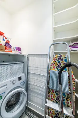a clothes rack in a laundry room with a washing machine at Stylish Apartment in Belgrade Waterfront in Belgrade