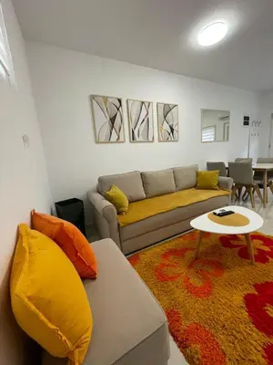 a living room with a couch and a table at LEDA Apartmani in Smederevo