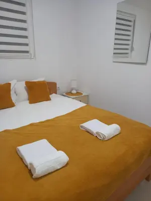a bedroom with a bed with two towels on it at LEDA Apartmani in Smederevo