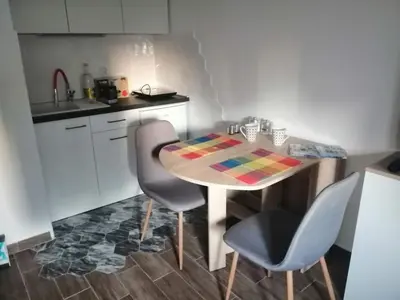 a kitchen with a table and two chairs and a kitchen with a sink at Caviar in Belgrade