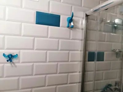 a bathroom with a shower with a toothbrush on the wall at Caviar in Belgrade