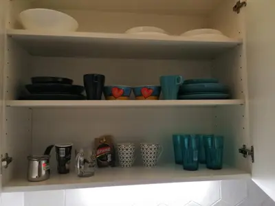 a shelf with plates and utensils in a kitchen at Caviar in Belgrade