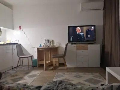 a living room with a tv and a table and chairs at Caviar in Belgrade