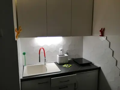a kitchen with a sink and a counter with a light at Caviar in Belgrade