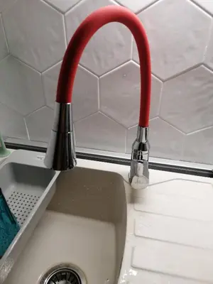 a red faucet over a kitchen sink at Caviar in Belgrade