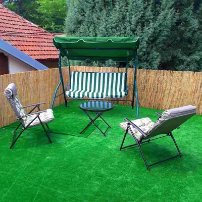 a gazebo with two chairs and a table on grass at Apartman Green Garden Aranđelovac in Arandjelovac