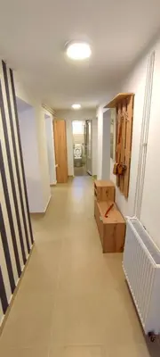 an empty room with a hallway with a room with boxes at Apartman Green Garden Aranđelovac in Arandjelovac