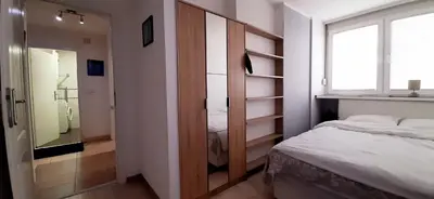 a small bedroom with a bed and a window at Apartman Šumice in Vračar (historical)