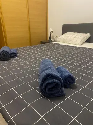 a bed with blue towels on top of it at Lord's Apartment in Belgrade