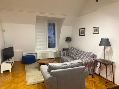 a living room with a couch and a television at Lord's Apartment in Belgrade