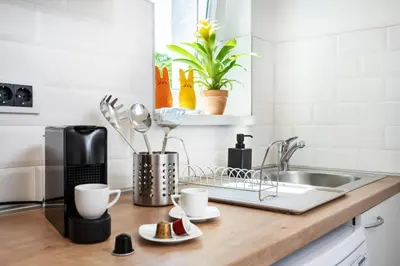 a kitchen counter with coffee cups and a sink at Studio apartment Financial Park Belgrade in Belgrade