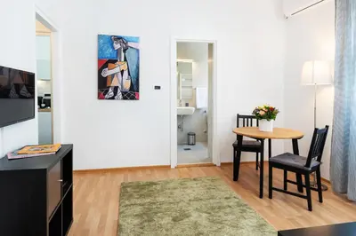 a living room with a table and a dining room at Studio apartment Financial Park Belgrade in Belgrade