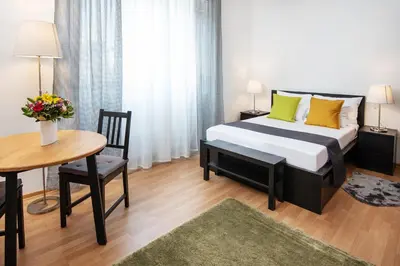 a hotel room with a bed and a table and a table sidx sidx at Studio apartment Financial Park Belgrade in Belgrade