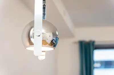 a light hanging from a wall in a hospital room at Apartment Atrium- A blok in Novi Beograd
