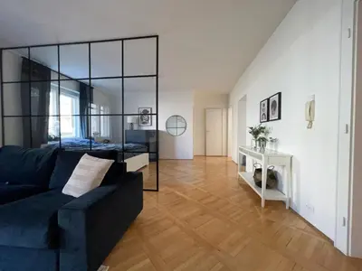 a living room with a blue couch and a mirror at Alva Lux Apartment in Belgrade