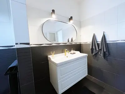 a bathroom with a white sink and a mirror at Alva Lux Apartment in Belgrade