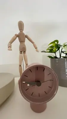 a wooden doll standing on top of a clock at Alva Lux Apartment in Belgrade