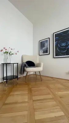 a living room with a chair and a table at Alva Lux Apartment in Belgrade