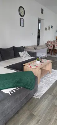 a living room with a couch and a table at Apartman Bajka in Ruma