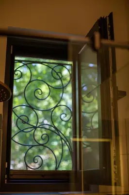 a glass door with a window with a tree at Cosy studio apartment in a heart of the Belgrade in Belgrade