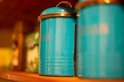 two blue canisters sitting on top of a shelf at Cosy studio apartment in a heart of the Belgrade in Belgrade