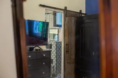 a room with a television and a dresser with a mirror at Cosy studio apartment in a heart of the Belgrade in Belgrade