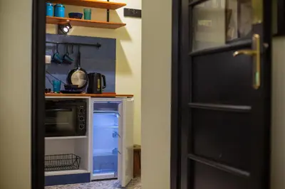 a kitchen with a stove and an open refrigerator at Cosy studio apartment in a heart of the Belgrade in Belgrade