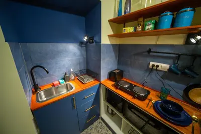 a small kitchen with a sink and a stove at Cosy studio apartment in a heart of the Belgrade in Belgrade