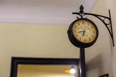 a clock hanging on a wall next to a door at Cosy studio apartment in a heart of the Belgrade in Belgrade